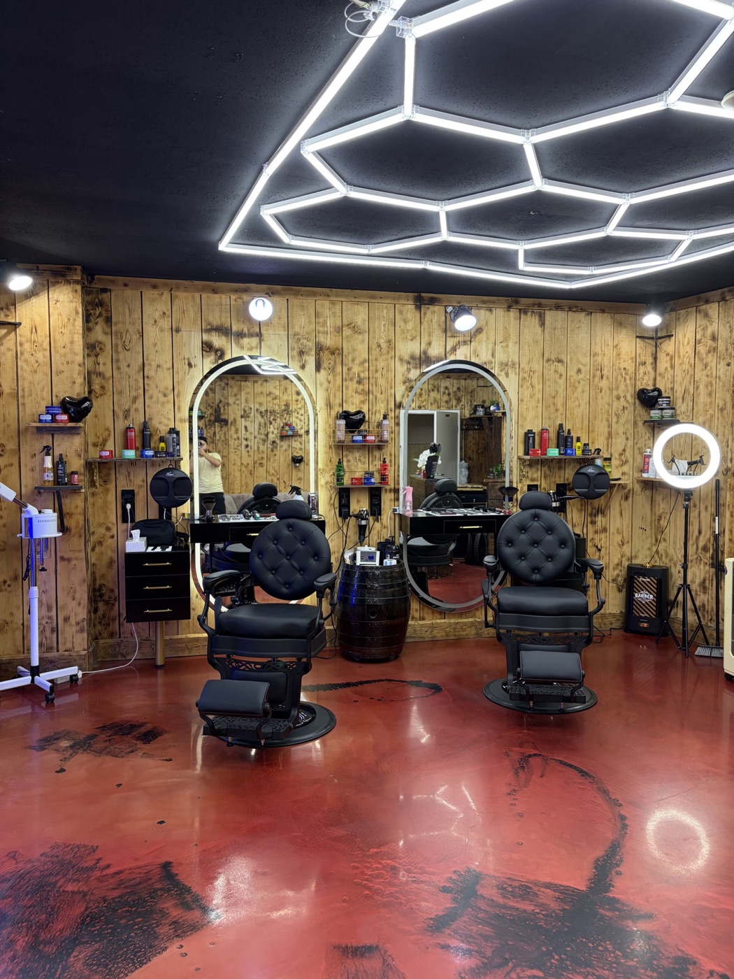 Zwei klassische Barber-Stühle vor beleuchteten Spiegeln